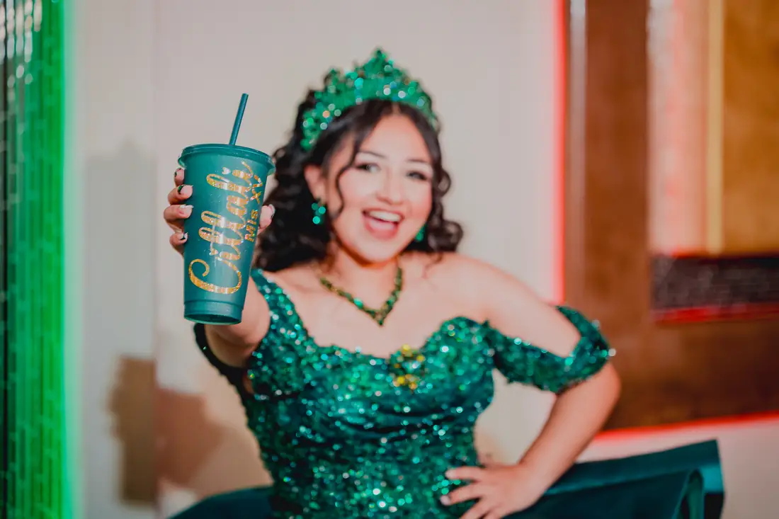 Emerald quinceañera gown under the grand chandelier, Celebration Hall Mission TX
