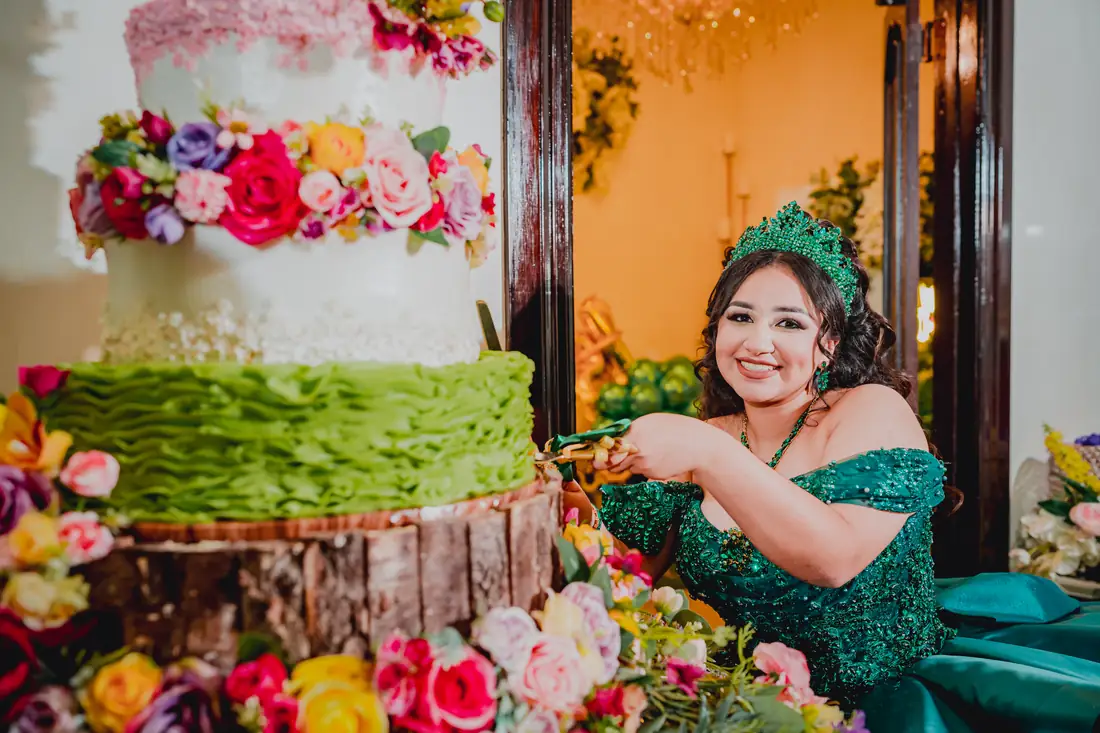 Quinceañera beneath crystal chandeliers at Arelis Celebration Hall