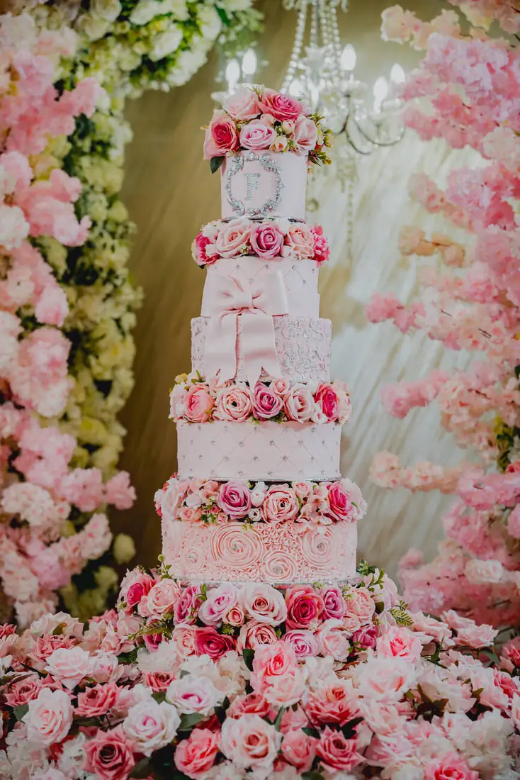 Pink tiered quinceañera cake with florals at The Grand Villa, Mission Texas