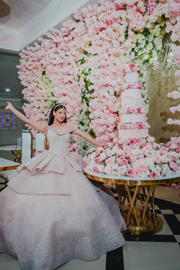 Quinceañera beside the cherry blossom display at The Grand Villa in Mission TX