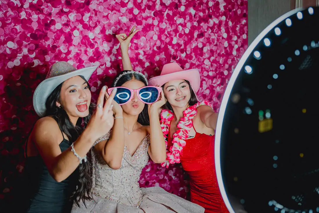 Photo booth fun with props at a Grand Villa quinceañera celebration