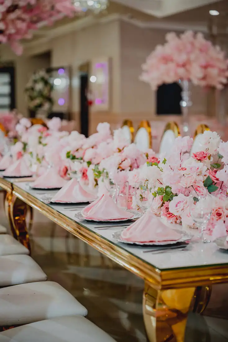 Gold table setting with blush florals at The Grand Villa reception hall