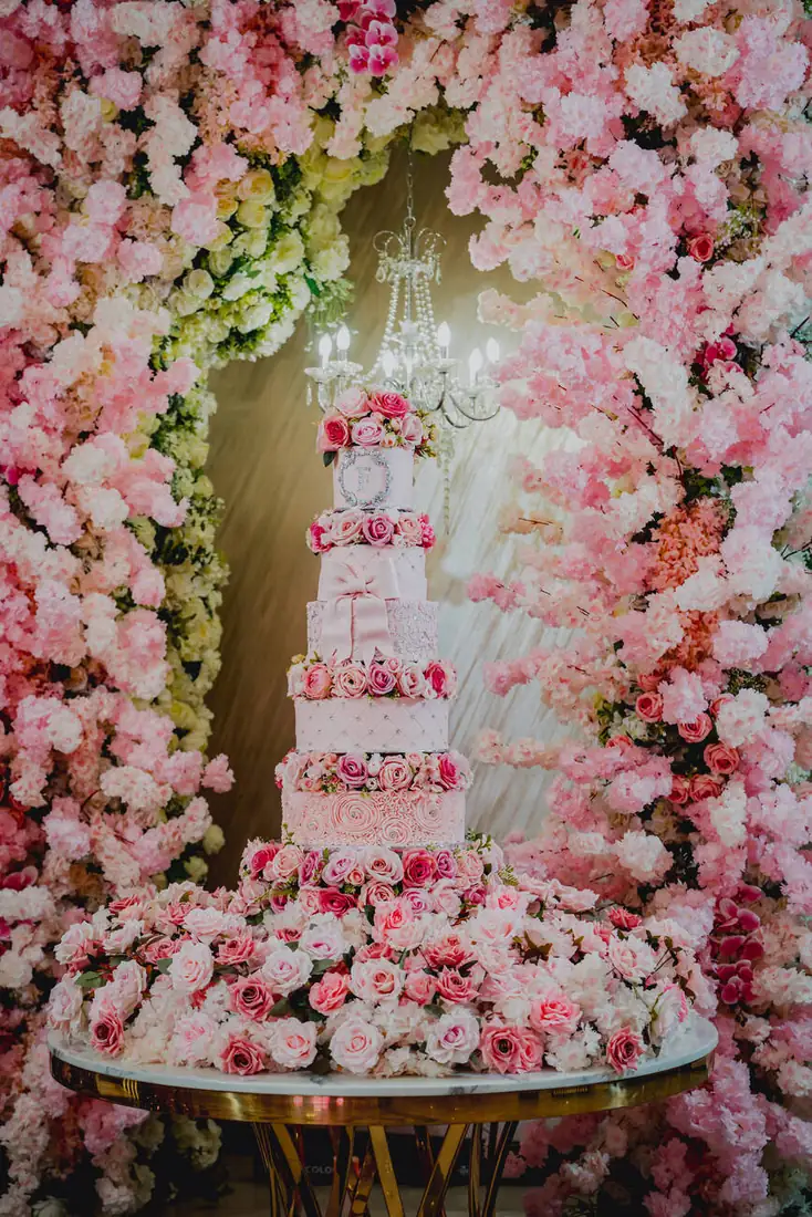 Flower arch cake display at The Grand Villa quinceañera, Mission Texas