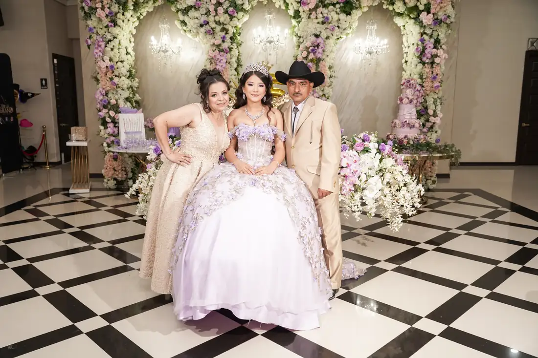 Family portrait on the checkered marble floor at The Grand Villa