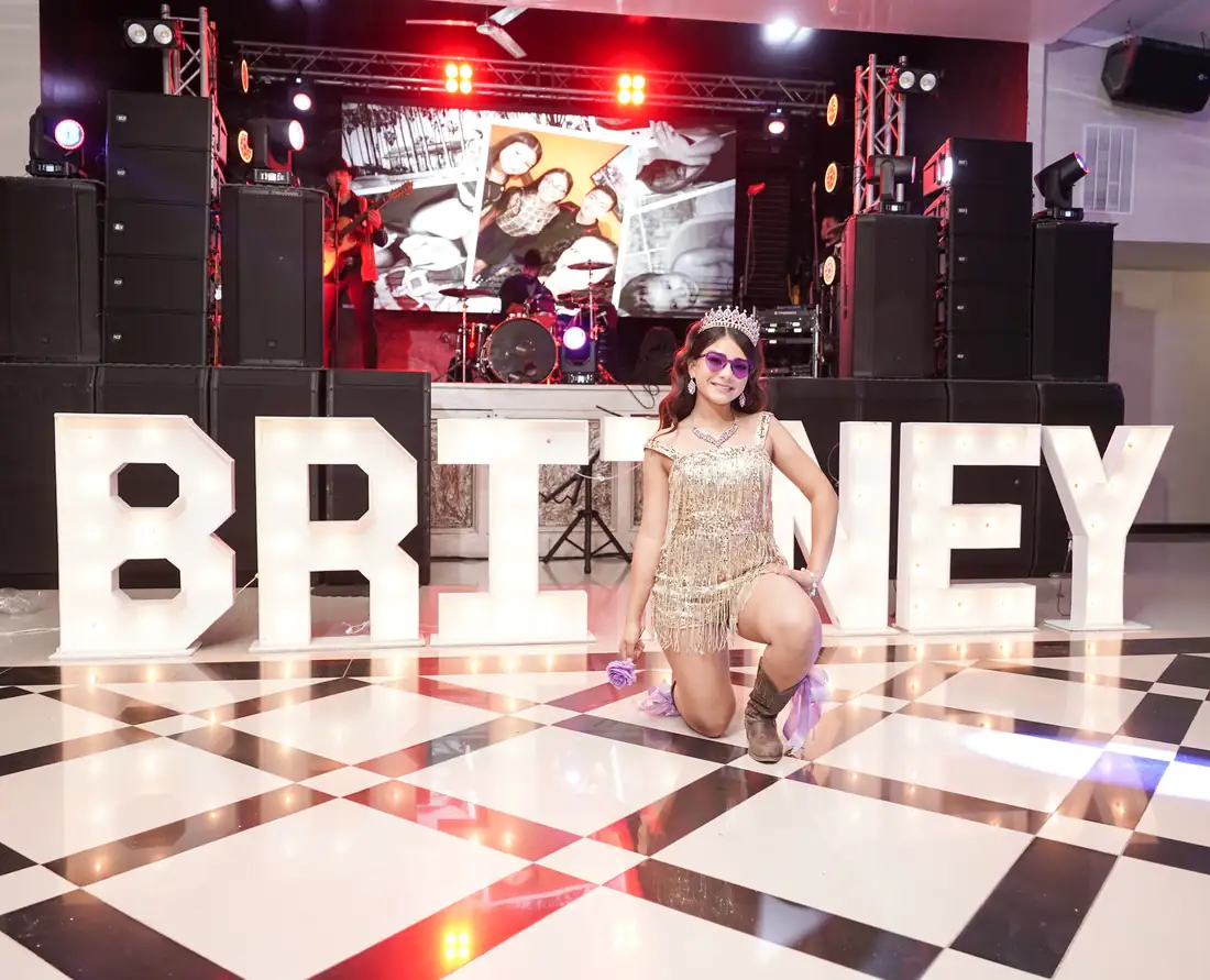 Live band and marquee letters on stage at The Grand Villa